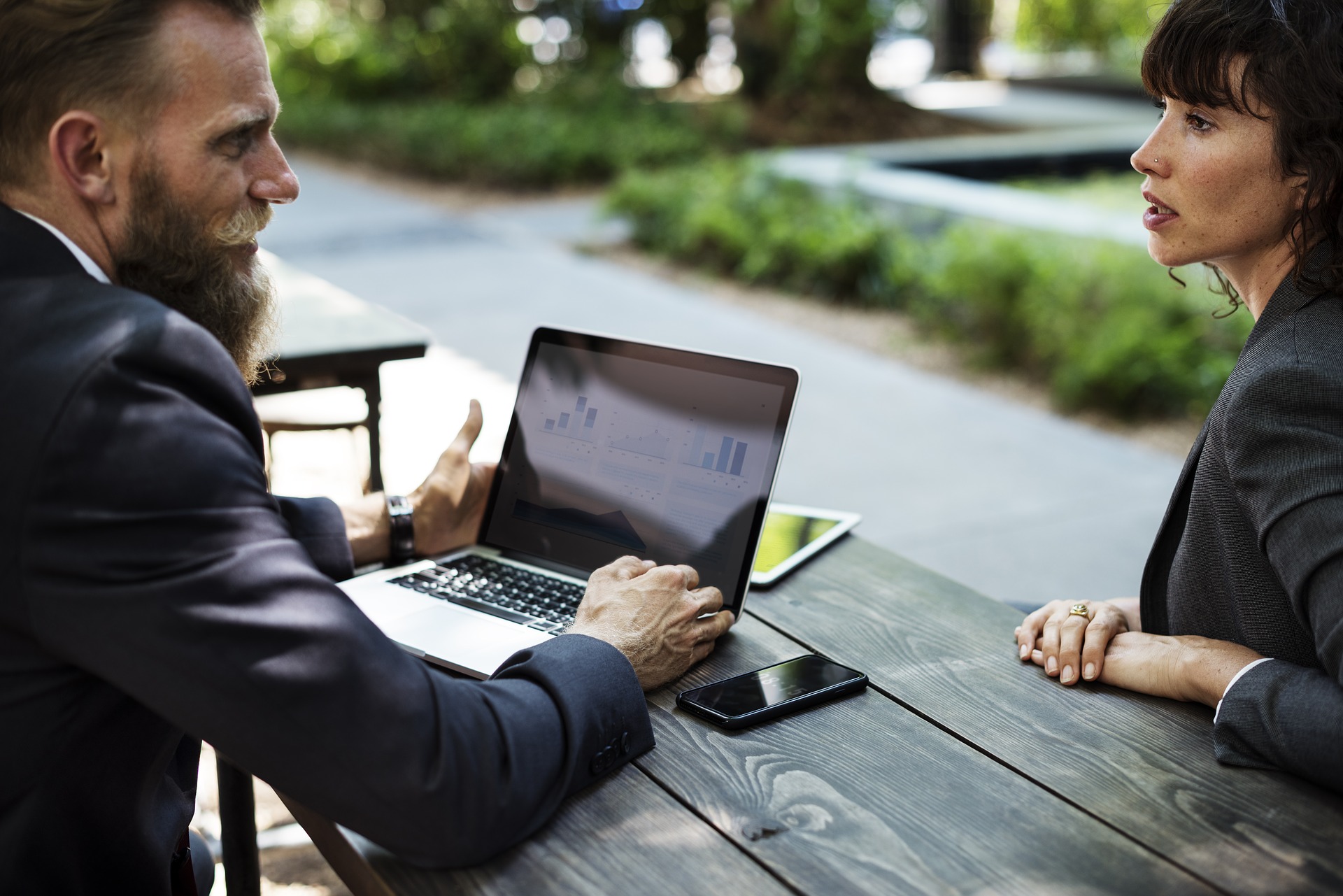 man-woman-talking-over-laptop